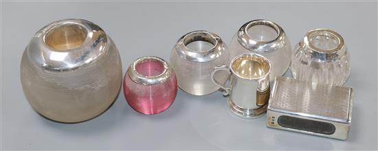 Five assorted silver mounted glass match tidies, a silver matchbox sleeve and a miniature silver mug.